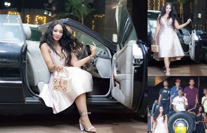 Zari strikes a pose in her convertible and inset are her soldiers